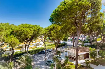 an aerial view of a parking lot with trees at Apartamento Farol com piscina e estacionamento in Vilamoura