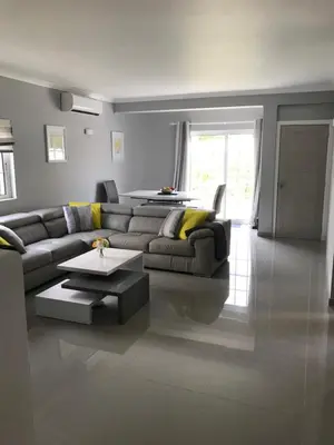 a living room with a couch and a table at 4 Bedroom Villa with Heated Pool close to Old Village in Vilamoura