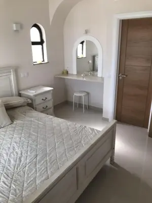 a bedroom with a bed and a sink and a mirror at 4 Bedroom Villa with Heated Pool close to Old Village in Vilamoura