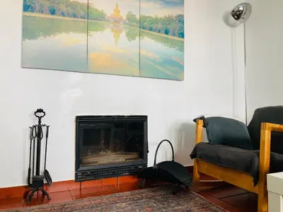 a living room with a fireplace and a painting on the wall at Villa 2BDR with sea view, private pool in Albufeira