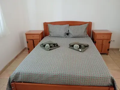 a bedroom with a bed with two towels on it at Albufeira INN - Mulatinho V2 in Olhos de Água