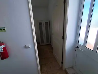 a hallway with a door and a room with a window at Albufeira INN - Mulatinho V2 in Olhos de Água