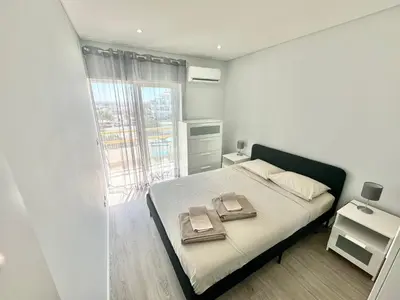a bedroom with a bed with two towels on it at Julio Apartment in Albufeira