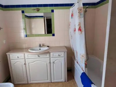 a bathroom with a sink and a shower curtain at Albufeira INN - Mulatinho V3 in Olhos de Água