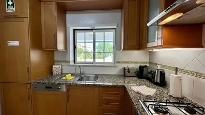 a kitchen with a sink and a window at Pine Cliffs by Check-in Portugal in Albufeira