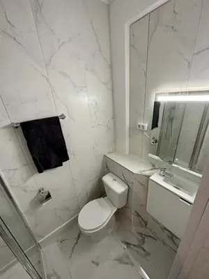 a bedroom with two beds and a desk in it at Albufeira flats in Albufeira