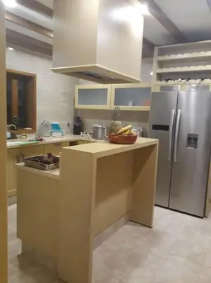 a kitchen with a refrigerator and a counter top at Casa Monte das Medronheiras in Vale Covo