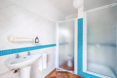 a bathroom with a sink and a shower at Urban Bliss Guesthouse I in Faro