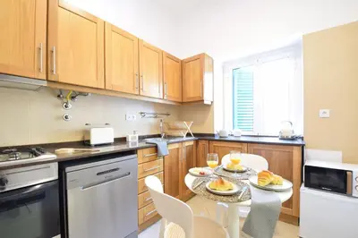 a kitchen with a table with plates of food on it at Urban Bliss Guesthouse I in Faro