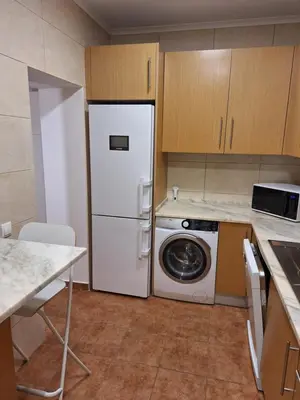 a kitchen with a white refrigerator and a washing machine at Monteverde in Monte Negro