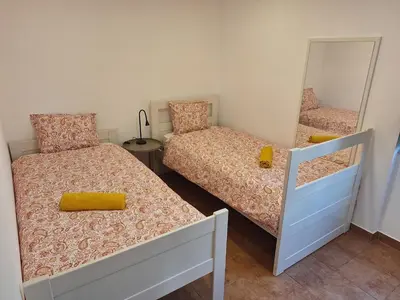 a bedroom with two beds and a mirror at Monteverde in Monte Negro