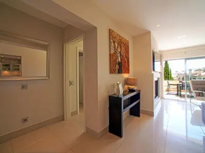 a living room with a table and a mirror at Apartment Pine Hills Diamante-12 by Interhome in Vilamoura