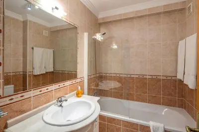 a bathroom with a sink and a bath tub at Lovely 2-Bed Apartment in Sao Rafael in Albufeira