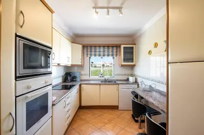 a kitchen with white appliances and a window at Lovely 2-Bed Apartment in Sao Rafael in Albufeira