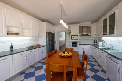 a kitchen with a wooden table with a bowl of fruit on it at Ma Vie La in Vale de Carros