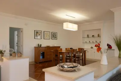 a kitchen and living room with a table and chairs at Ma Vie La in Vale de Carros