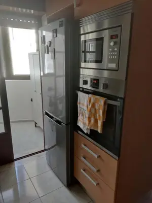 a kitchen with a refrigerator and a microwave at Faro Stadium Flat by Freetimealgarve in Faro