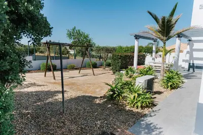 a swing set in front of a house at Villa Jorge by Ecovillas Albufeira in Galé