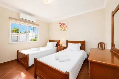 a kitchen with an outdoor oven next to a swimming pool at Villa Amendoeira in Albufeira