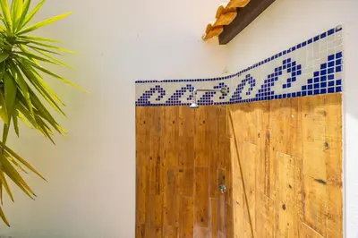 a kitchen with wooden cabinets and a table and chairs at Villa Amendoeira in Albufeira