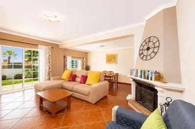 a living room with a couch and a fireplace at Villa Amendoeira in Albufeira
