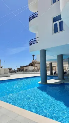 two chairs and a table on a balcony at The Navigator - Ocean Heights in Olhos de Água