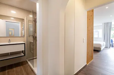 a bathroom with a shower and a sink and a mirror at The Navigator - Ocean Heights in Olhos de Água