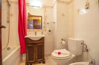 a bathroom with a toilet and a sink and a mirror at Old Village- 1A Village Gate in Quarteira