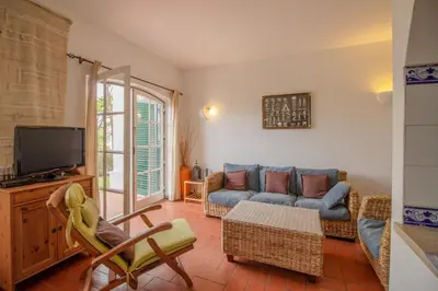 a living room with a couch and a tv at Old Village- 1A Village Gate in Quarteira
