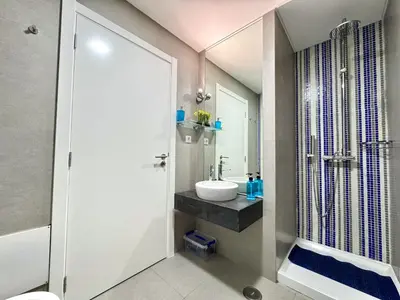 a bathroom with a toilet and a sink and a shower at Vilamoura Club Villa 1 With Pool by Homing in Vilamoura
