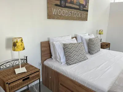 a bedroom with a bed with white sheets and pillows at Ocean view by Charmes Penthouse in Albufeira