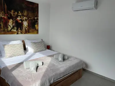 a bedroom with a bed with a painting on the wall at Ocean view by Charmes Penthouse in Albufeira