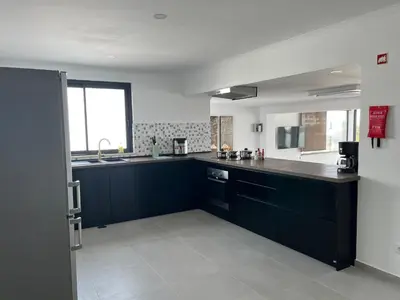 a kitchen with black cabinets and a counter top at Ocean view by Charmes Penthouse in Albufeira