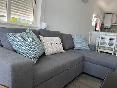 a gray couch with pillows in a living room at Ocean view by Charmes B in Albufeira