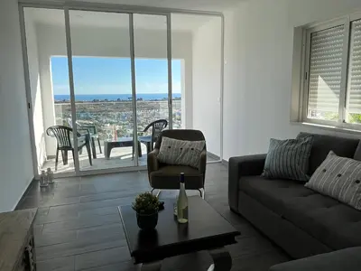 a living room with a couch and a chair at Ocean view by Charmes B in Albufeira