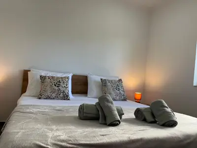 a bed with three pillows on top of it at Ocean view by Charmes B in Albufeira