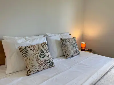 a white bed with pillows on it with at Ocean view by Charmes B in Albufeira