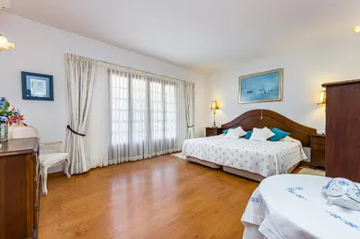 a bedroom with two beds and a large window at Albufeira Villa El-Gharb private 4 Bedrooms in Albufeira