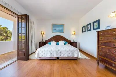 a bedroom with a bed with blue pillows on it at Albufeira Villa El-Gharb private 4 Bedrooms in Albufeira