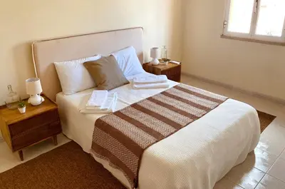 a bedroom with a large white bed with two night stands at T1 Vista Marina de Vilamoura in Vilamoura