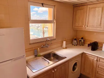 a kitchen with a sink and a window at T1 Vista Marina de Vilamoura in Vilamoura