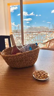 a basket on a table with a plate of peanuts at T1 Vista Marina de Vilamoura in Vilamoura