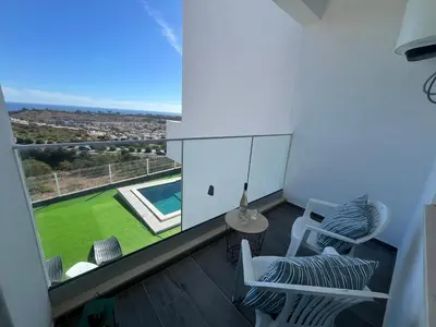 a room with a balcony with a view of a yard at Ocean view by Charmes C in Albufeira