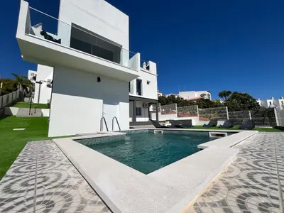 a house with a swimming pool next to a building at Ocean view by Charmes C in Albufeira