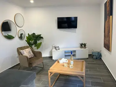 a living room with a couch and a table and a tv at Ocean view by Charmes A in Albufeira