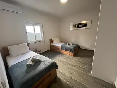 a room with two beds and a window at Ocean view by Charmes A in Albufeira
