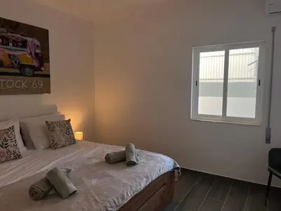 a bedroom with a large bed with a window at Ocean view by Charmes A in Albufeira