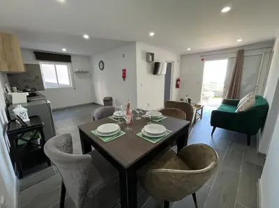 a living room with a dining room table and chairs at Ocean view by Charmes D in Albufeira