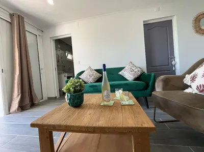 a living room with a green couch and a table at Ocean view by Charmes D in Albufeira