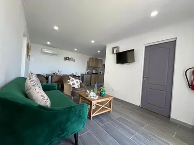 a living room with a green couch and a table at Ocean view by Charmes D in Albufeira